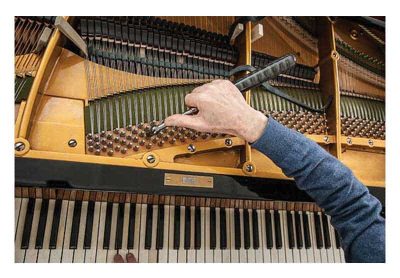 Photo of piano being tuned